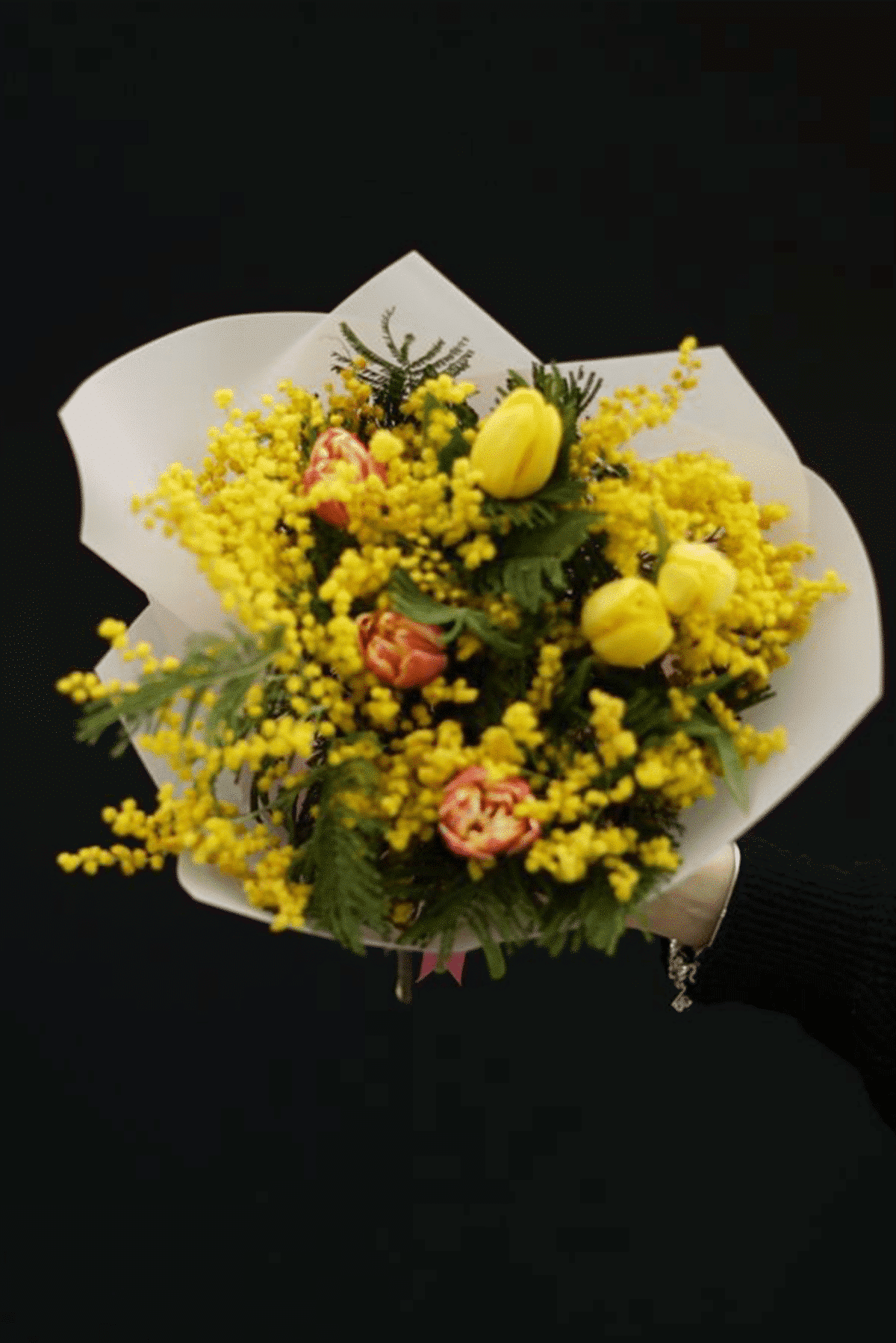 A bouquet of tulips and seasonal mimosas